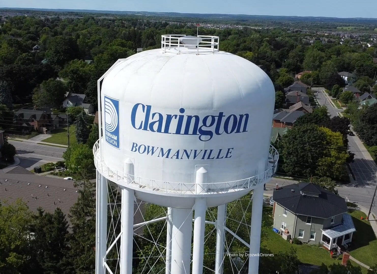 Bowmanville Water Tower An aerial photograph of a white water tower. The Durham region logo and words "Clarington Bowmanville" are in blue.